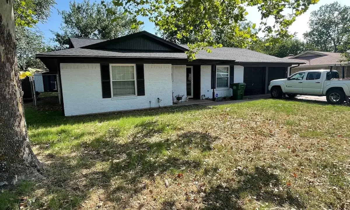 Professional roofing crew working on a residential roof in Howard